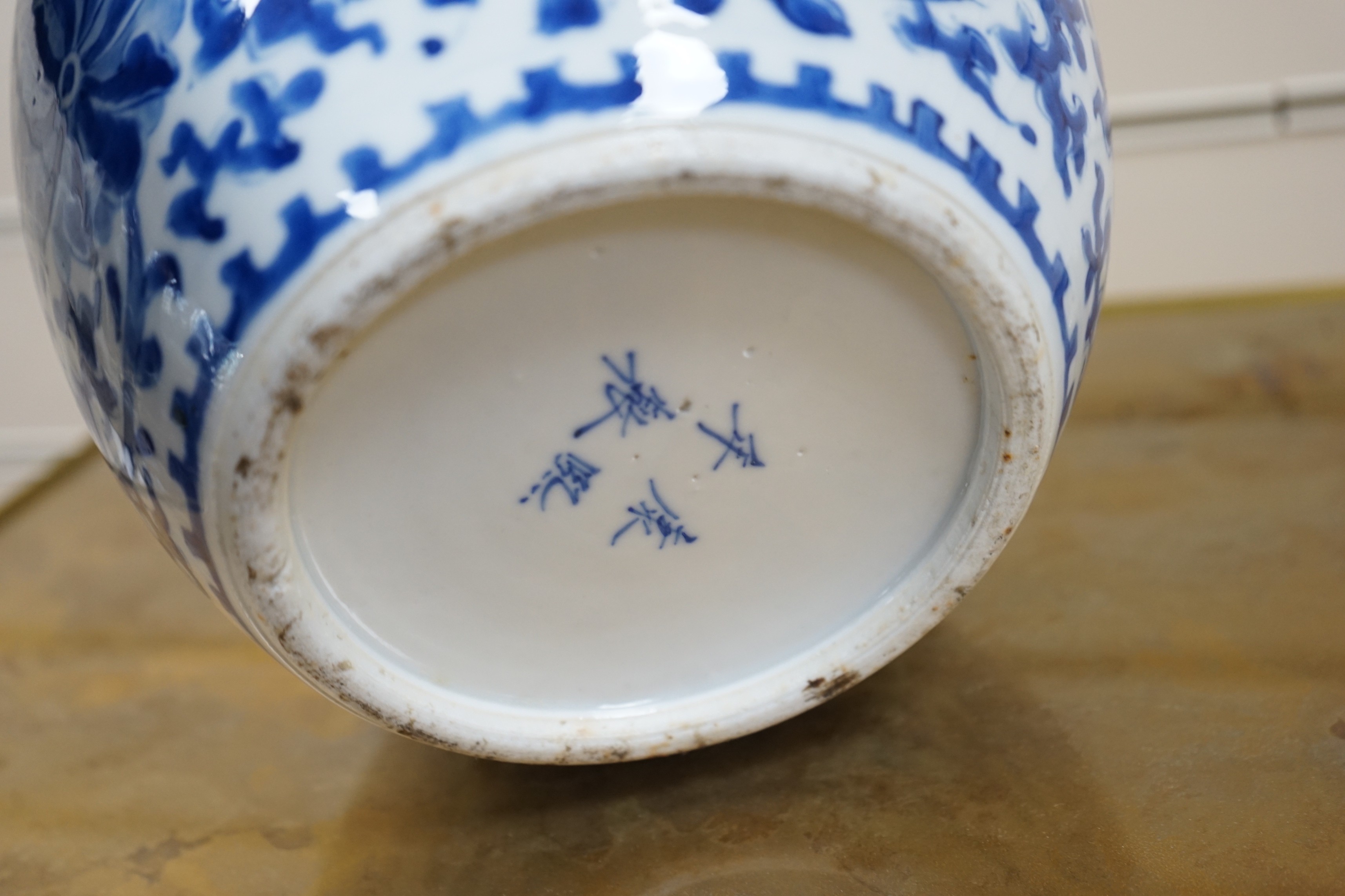 A late 19th century Chinese blue and white ovoid jar. 22cm tall, apocryphal Kangxi mark